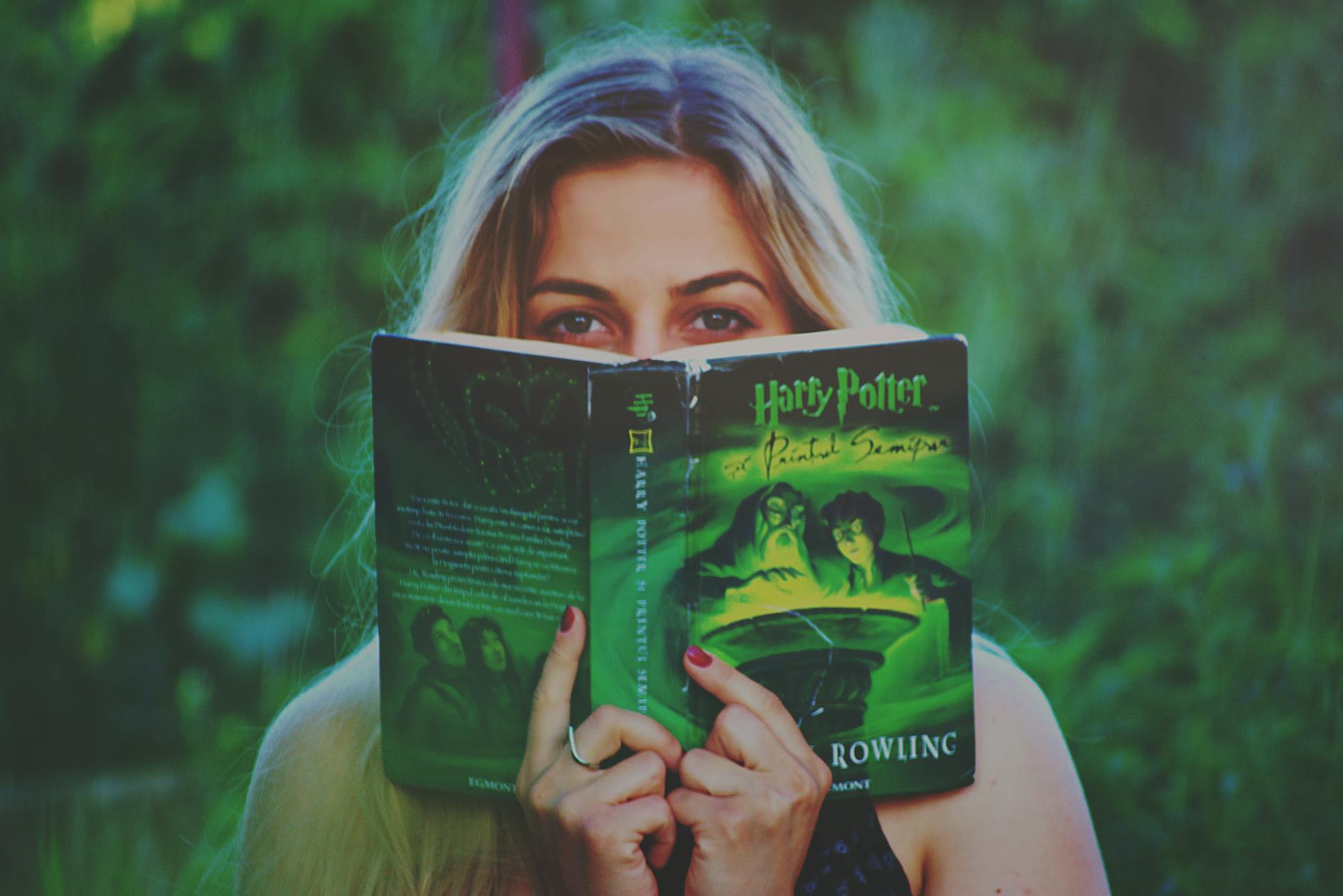 woman reading harry potter book- Magical Realism
