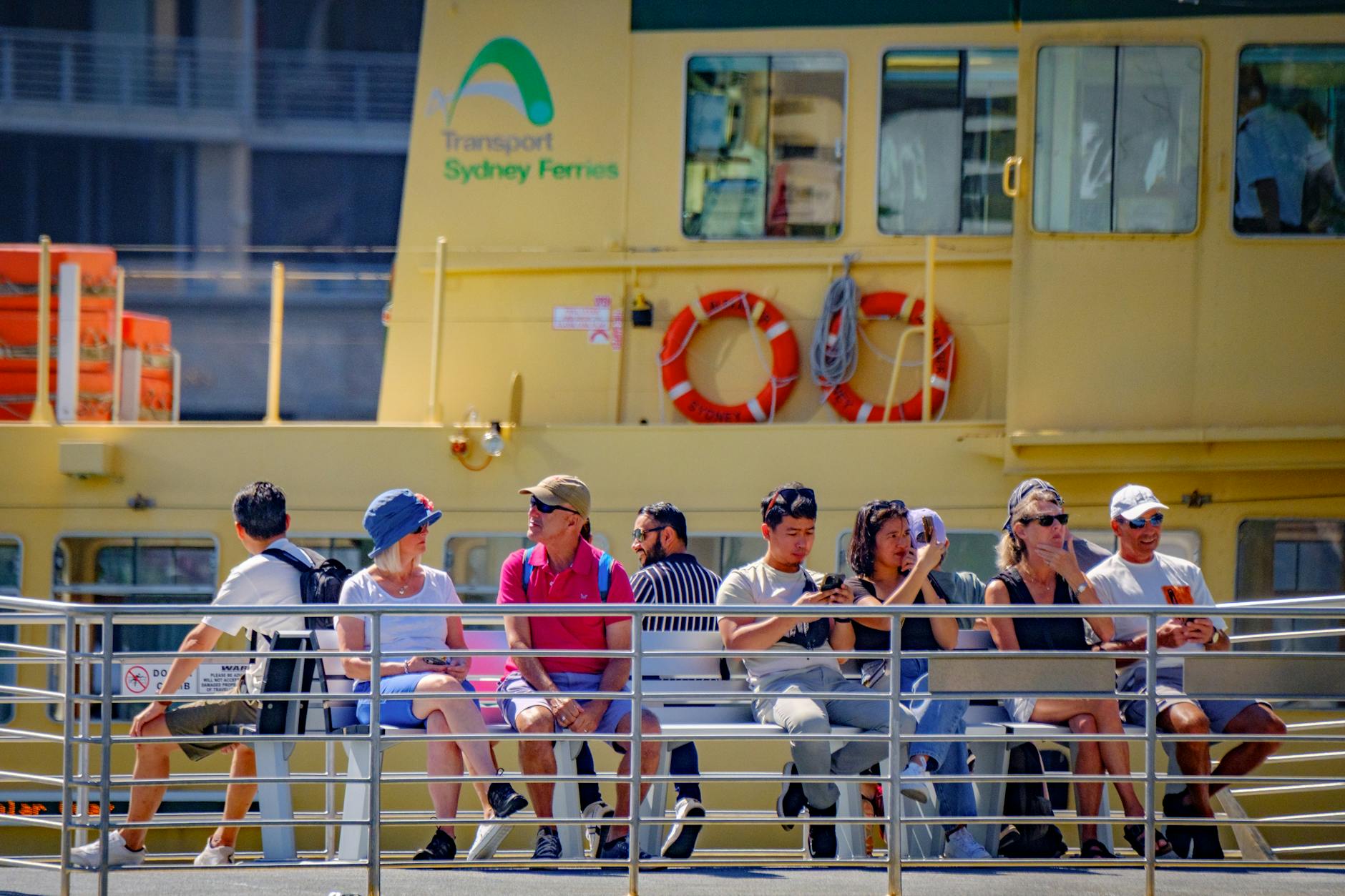 Casual passengers enjoy sunny sydney ferry ride. Sydney travel guide