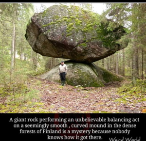 A giant rock performing an unbelieveable balance on a seemingly smooth,curved mound in forests of Finaland, breathtaking places