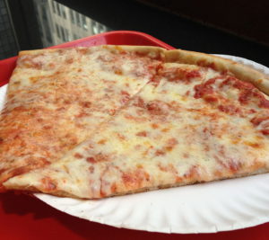 Slices of New York-style pizza to-go, street food USA