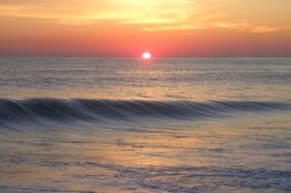 Sunset over ocean symbolizing Reentry with Purpose in mindful investing”