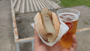 raditional Lisbon bifana sandwich with marinated pork in a crusty papo seco roll, served street‑side.