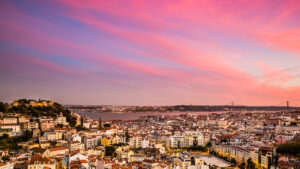 street food stalls and kiosks in Lisbon’s Alfama district, with locals enjoying snacks during a festival.