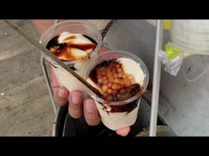 Taho, silken tofu with syrup and sago pearls, a comforting Filipino street food served at dawn in Manila.` 