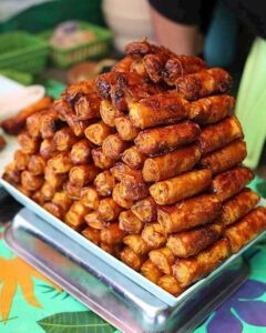Manila street food turon, a vegetarian friendly Filipino dessert of fried banana spring rolls.