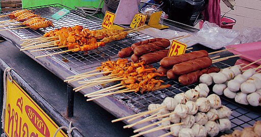 Thai street food skewers on charcoal grill in Thailand