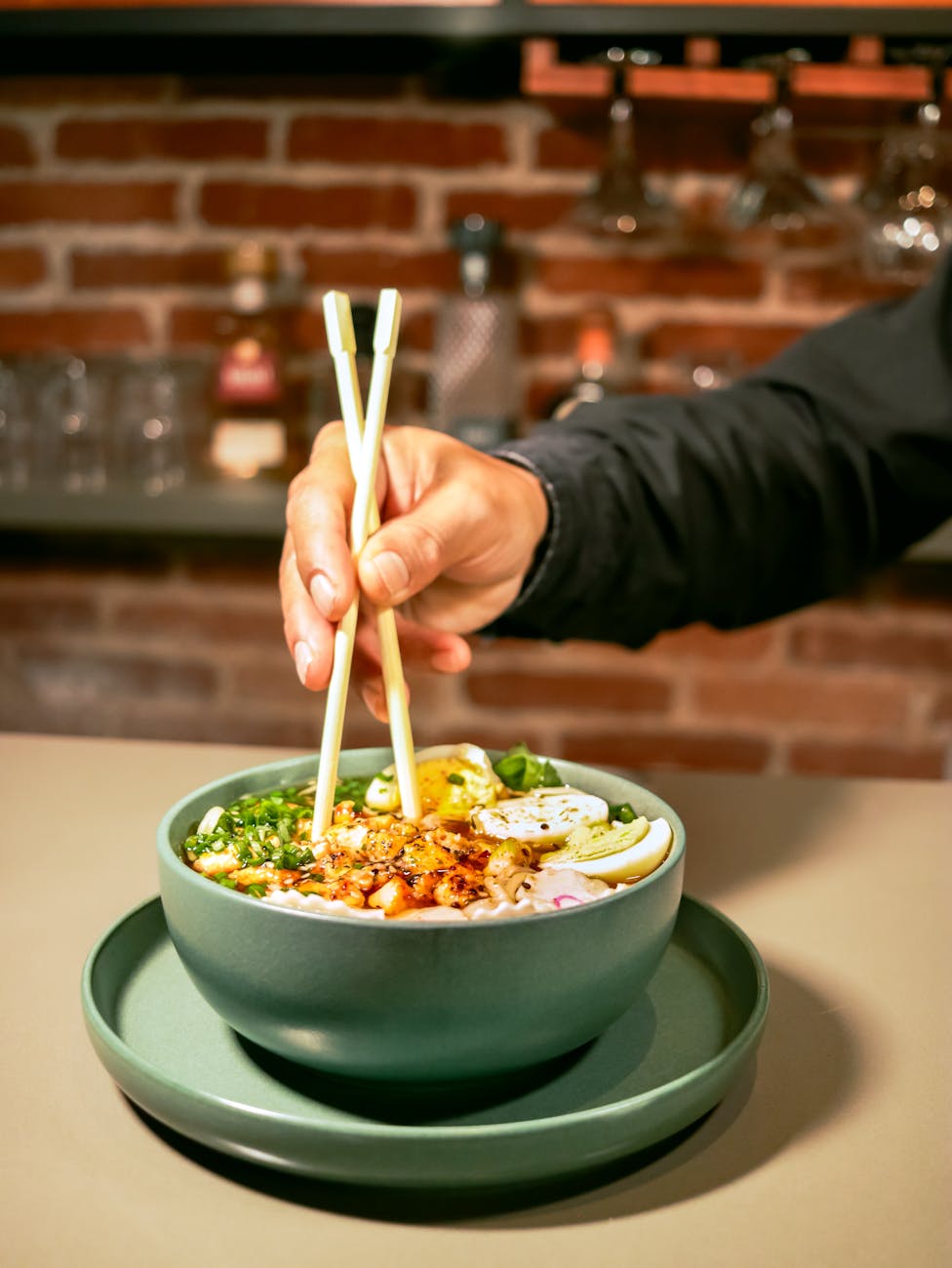 person enjoying ramen with chopsticks in cozy setting
Bowl of ramen in Tokyo