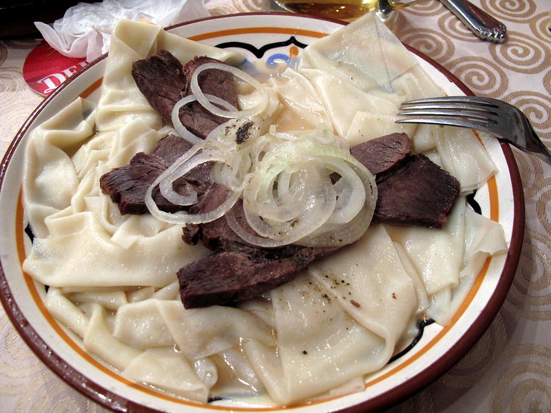 Silk Route Spring Food – Kyrgyz beshbarmak with wide noodles, meat, and onion broth”