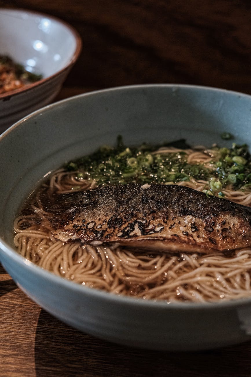 a close up shot of noodles in spring bowls
close‑up spring soba noodles in a bowl, Kyoto seasonal dish