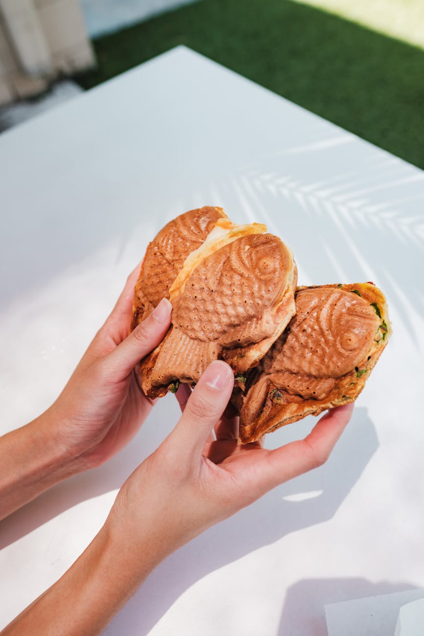 delicious taiyaki fish shaped waffles held outdoors- Tokyo street food diaries