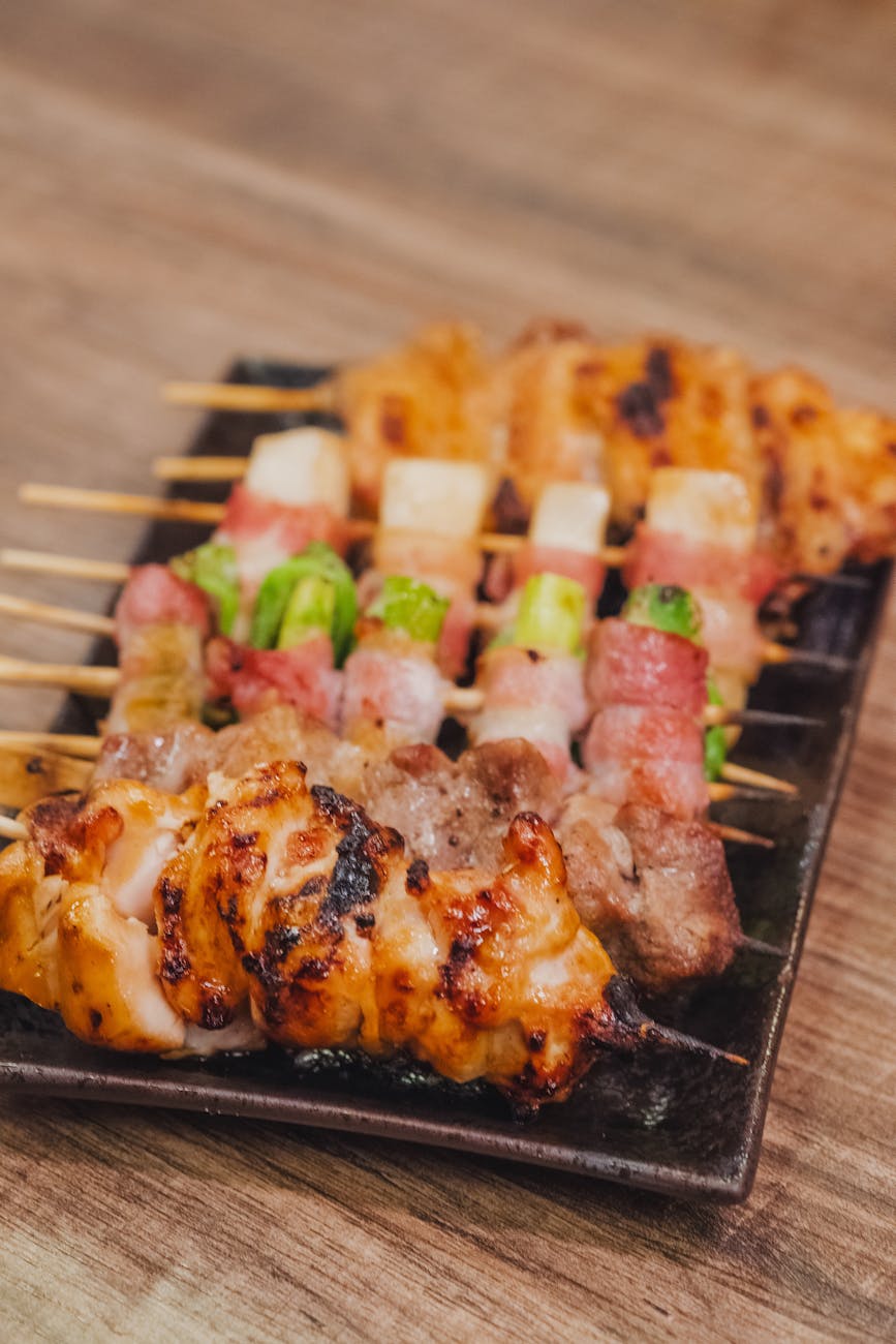 delicious grilled yakitori skewers on plate
Tokyo Street Food Diaries — yakitori sizzling on open grills