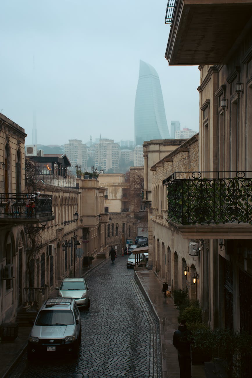 historic cobblestone street with flame towers view in baku. Old Town Baku stone alleys and historic walls in soft spring light. Caucasus Fruit Geography