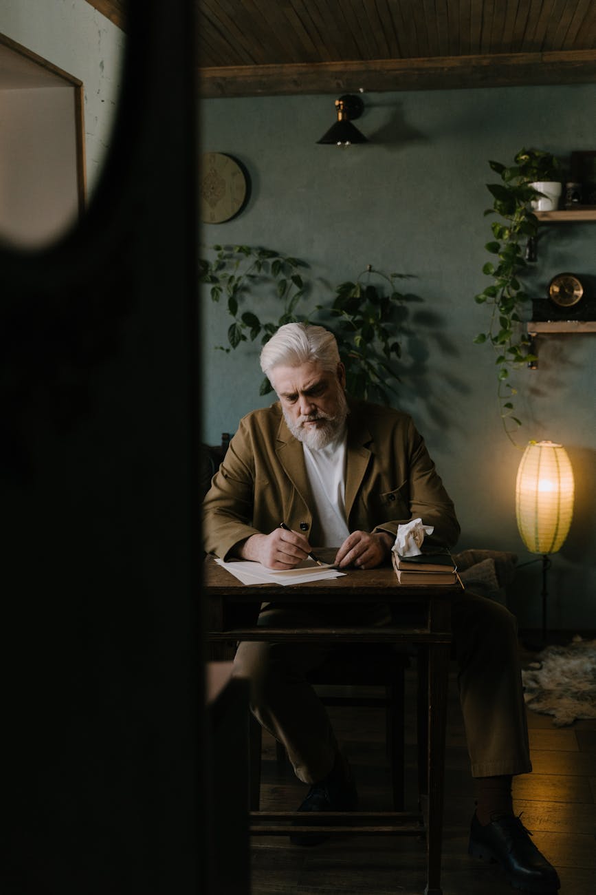 an elderly man composing a letter- Writer on World theatre day