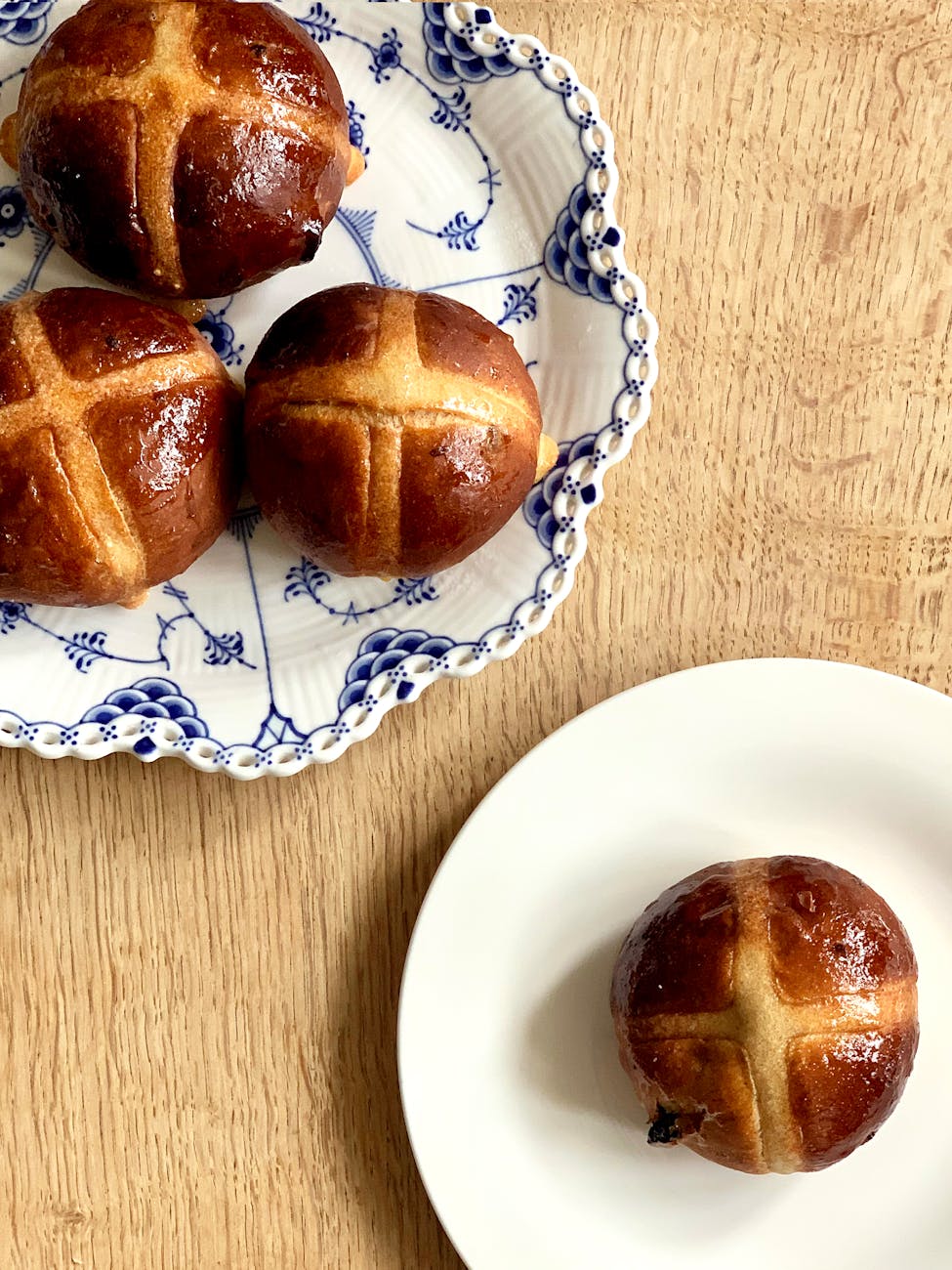 brown breads on white ceramic plate. Hot cross buns on Good Friday