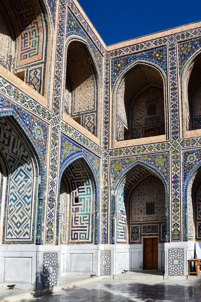Intricate tilework and arches of Ulugbek Madrasah in Samarkand, Uzbekistan