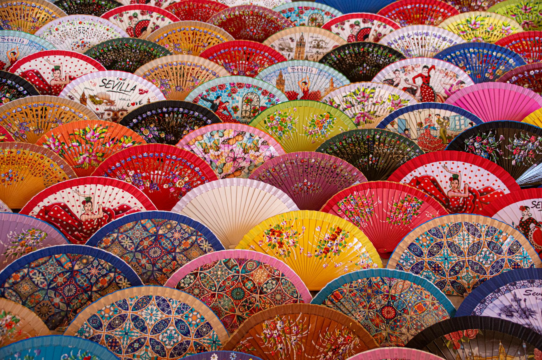 a display of hand fans in assorted colors and design.  Long‑form cultural storytelling collaborations