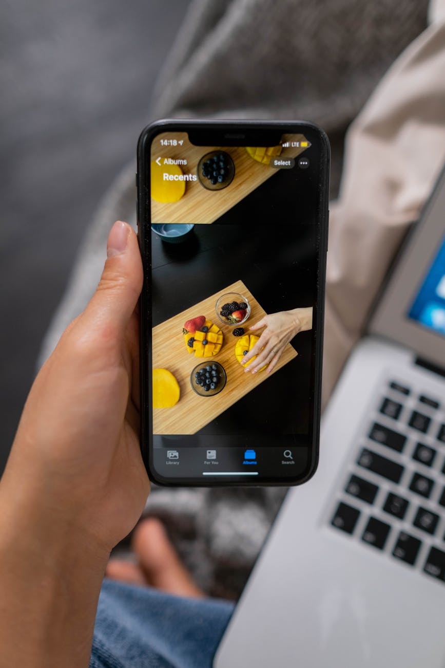 person holding black mobile phone. Social media collaborations for travel and culture brands