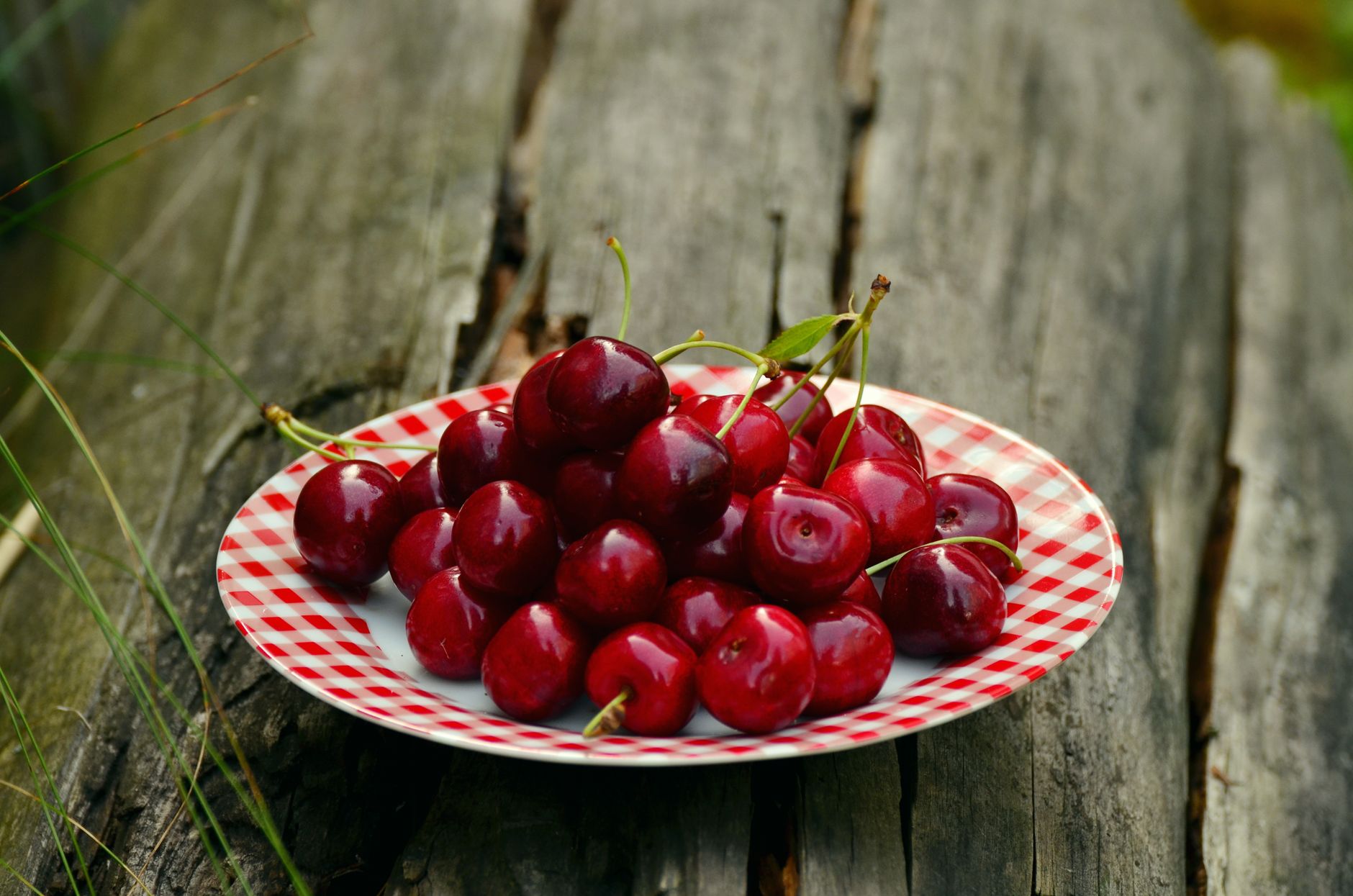 cherry fruits on white and red ceramic round plate