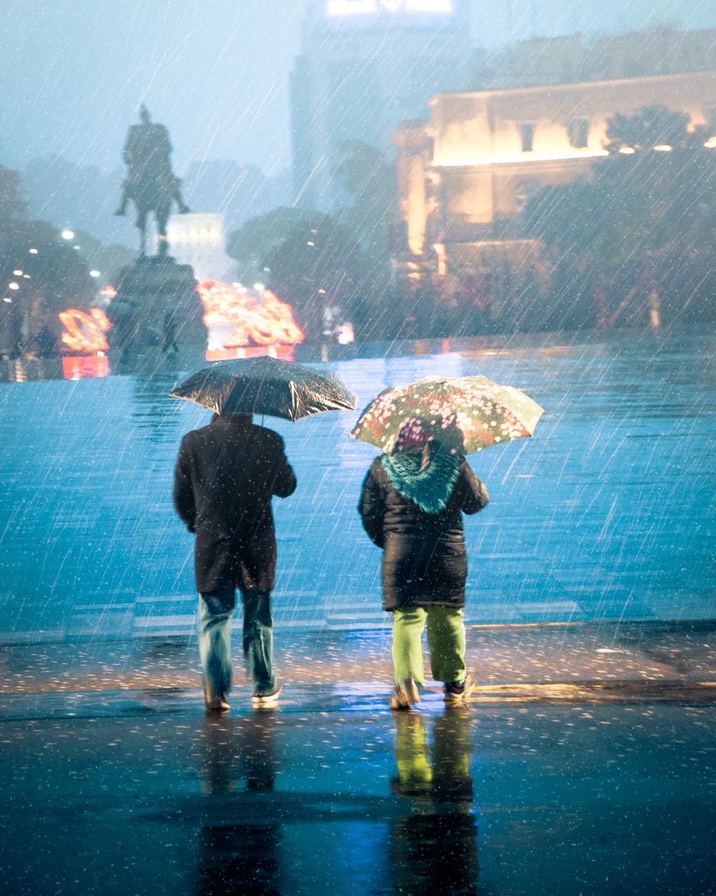 people using their umbrellas in rain. people walking in the first rain of July monsoon
