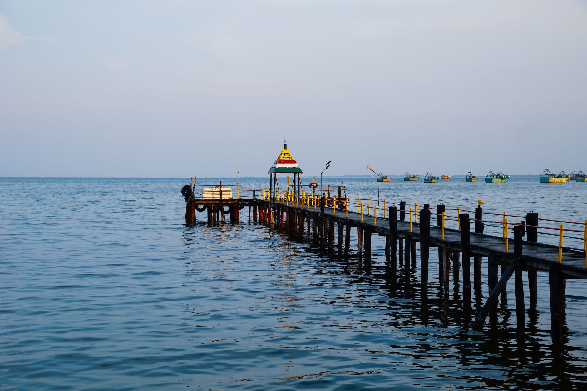 wooden dock with gazebo on sea.  El Niño monsoon break snorkeling India Rameswaram calm Palk Strait