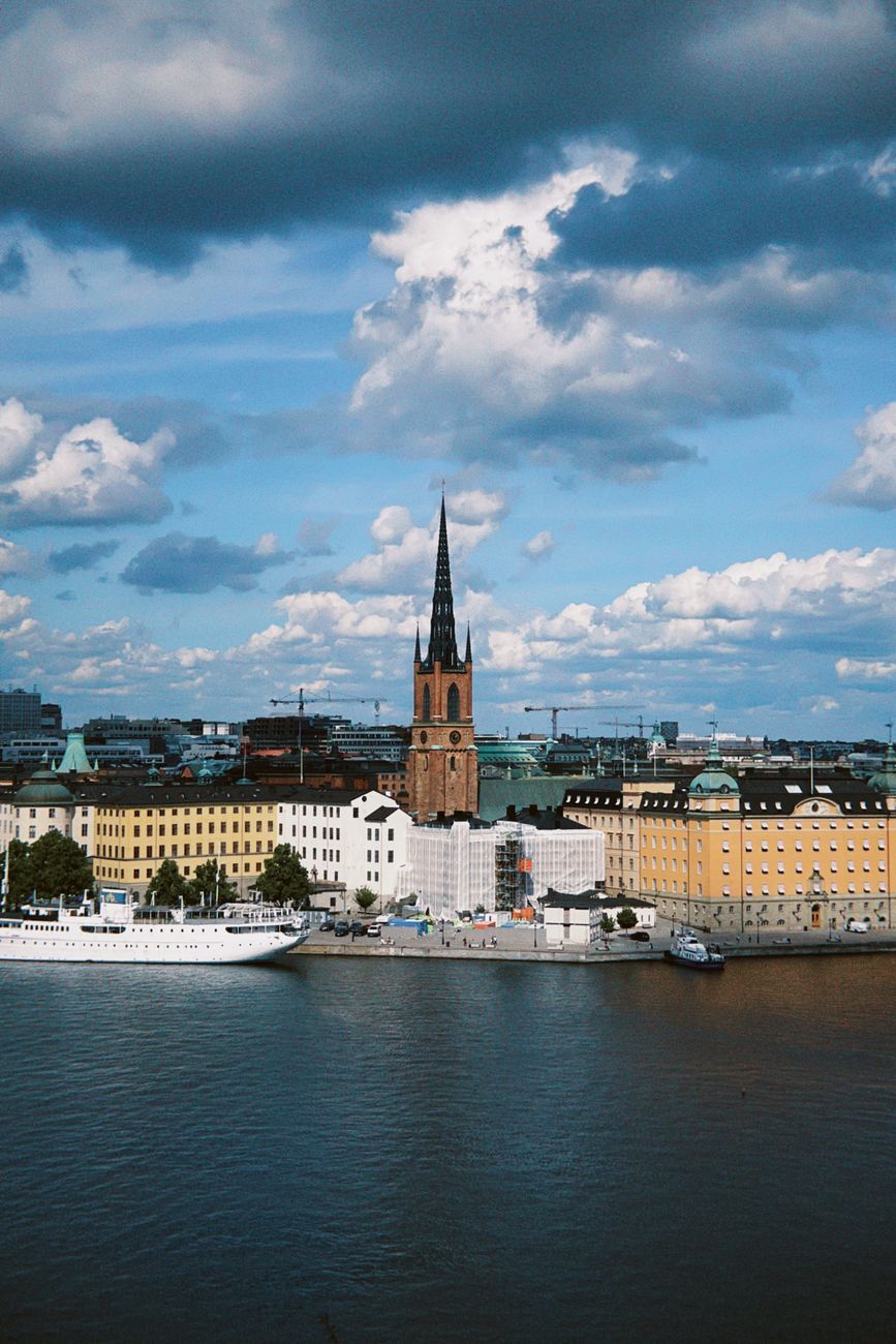 scenic view of stockholm waterfront and church. Early‑autumn light over Stockholm’s waterfront with calm water, boats, and a church tower reflecting Scandinavian clarity.