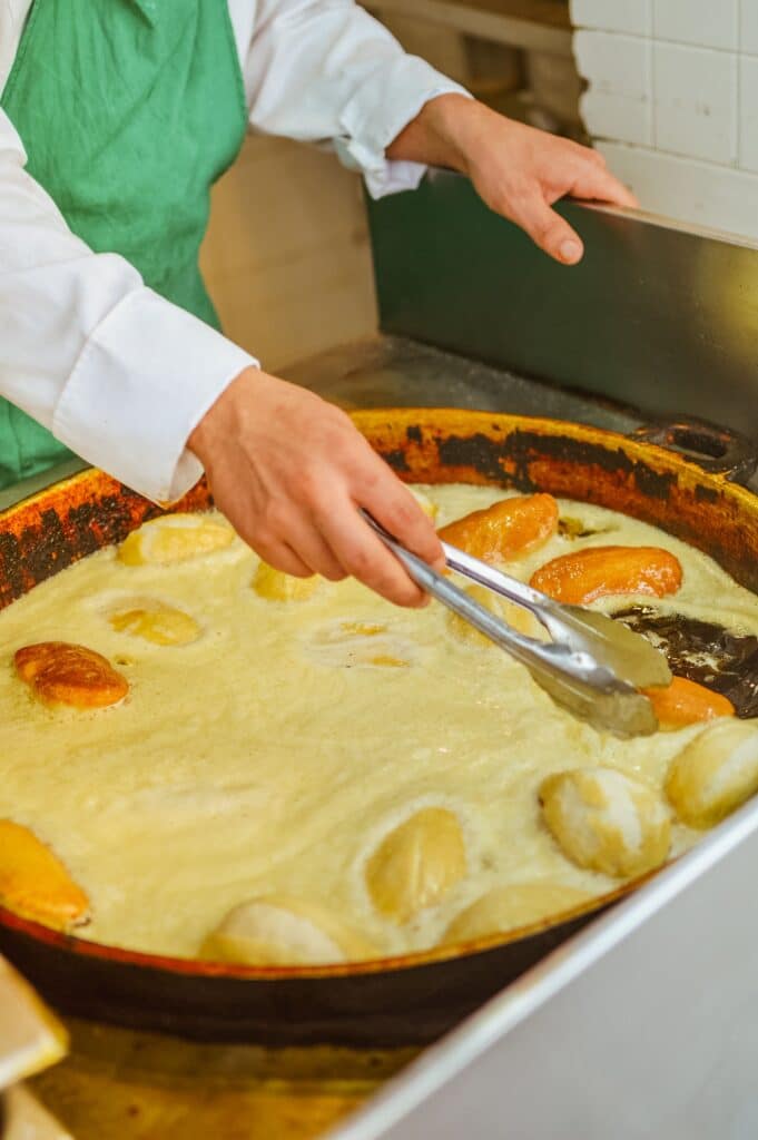 Traditional Tunisian brik pastry being prepared by hand