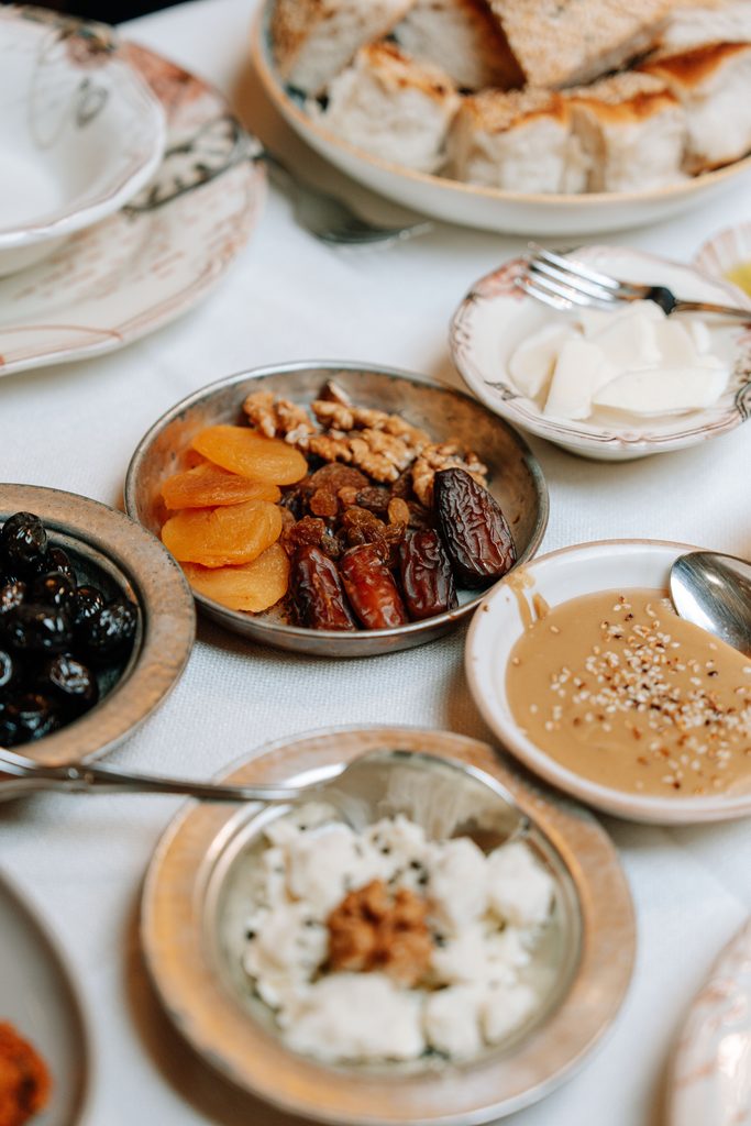 Traditional Egyptian breakfast spread featuring tahini, breads, vegetables, and shared mezze-style dishes.