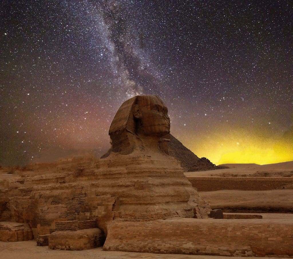 The Great Sphinx and the Pyramids of Giza rising above the desert landscape in Egypt.