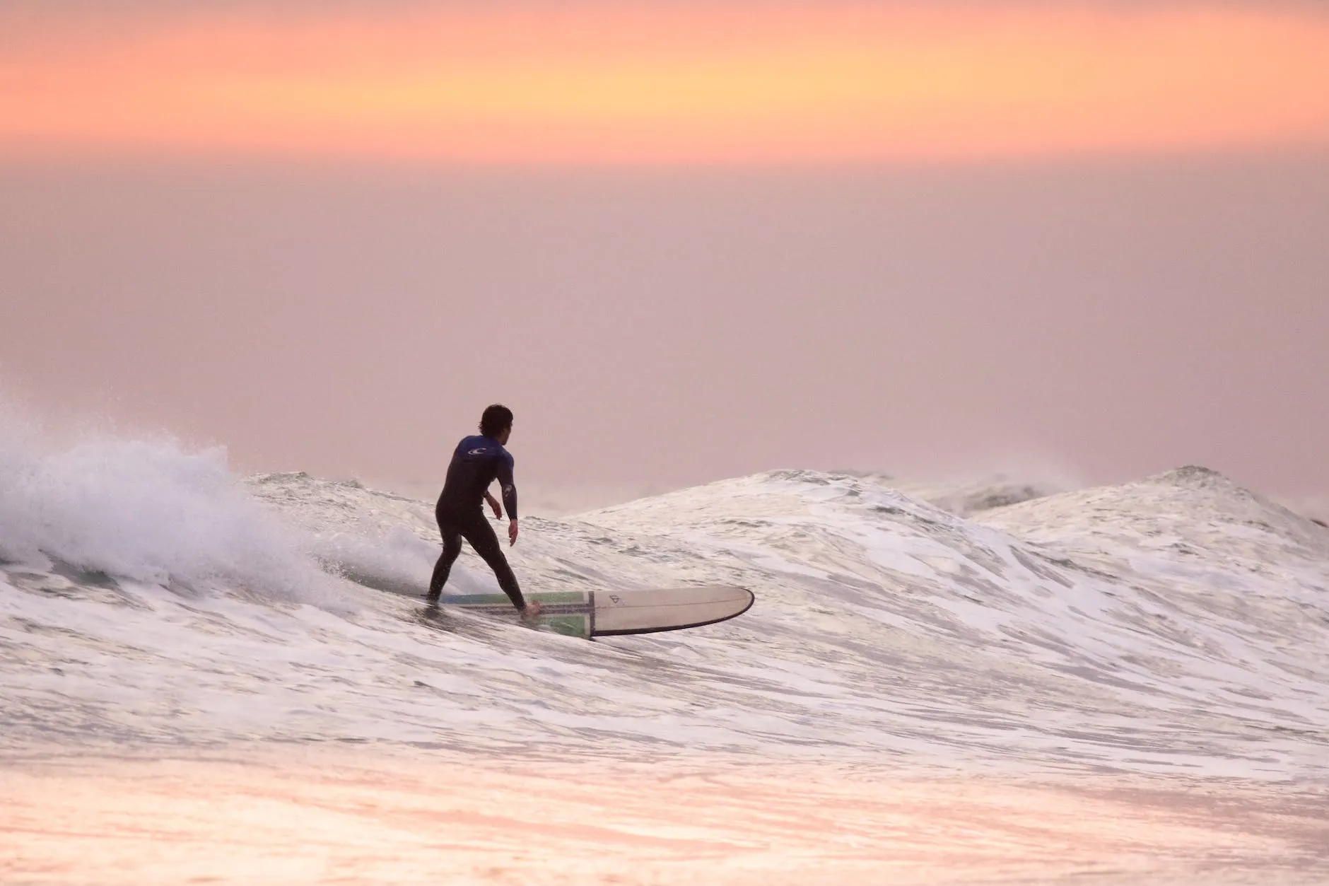 man doing surfing at golden hour