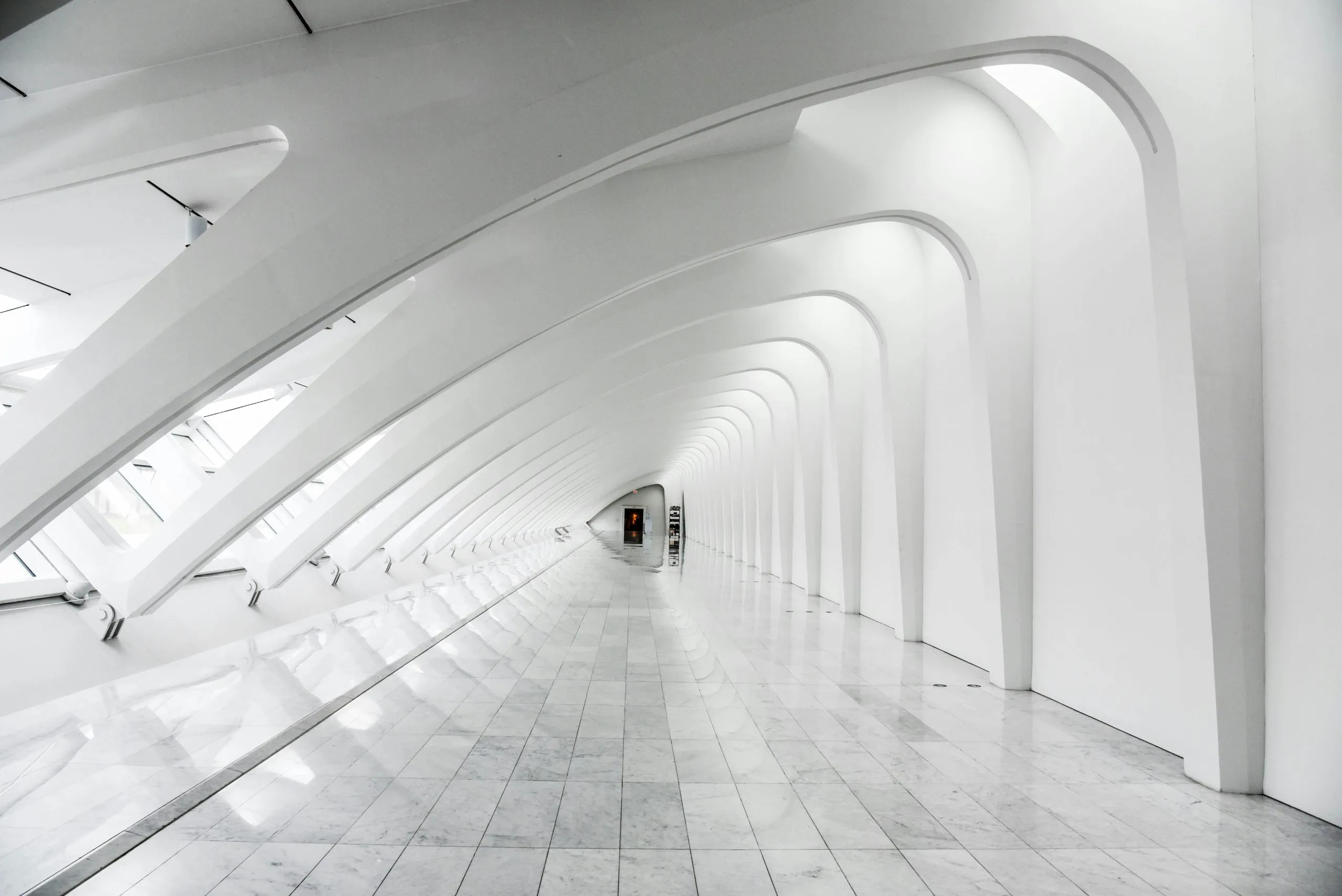Explore the sweeping modern arches and minimalistic design of the Milwaukee Art Museum's white hallway.